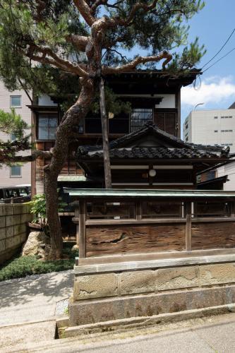a building with a tree in front of it at Close to you in Kanazawa