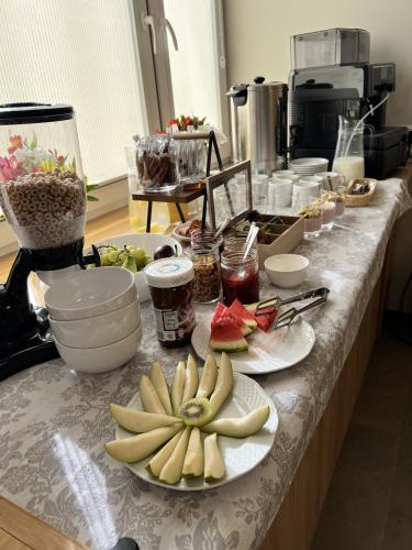a kitchen counter with plates of fruit on it at Apartamenty Efekt 72 in Gdynia