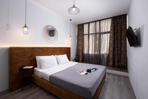 a hotel room with a bed and a window at Enattica Monastiraki Living in Athens