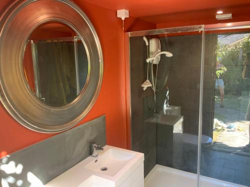 a bathroom with a sink and a mirror at The Goods Wagon, private garden and stunning views in High Buston