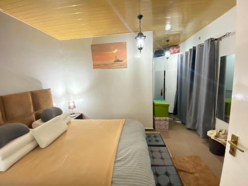 a bedroom with a large bed and a couch at Tranquil One Bedroom - Karen in Nairobi