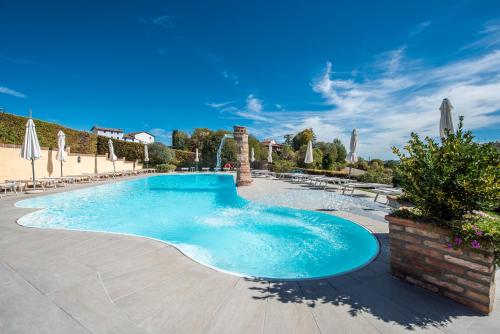 a large swimming pool with blue water at Casa del Nebbiolo in Camino