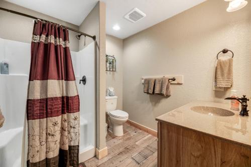 a bathroom with a sink and a toilet at Klassy Lodge in Sturgis