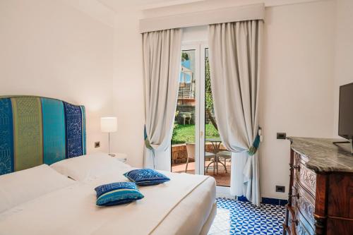 a bedroom with a bed and a television at San Montano Resort & Spa in Ischia