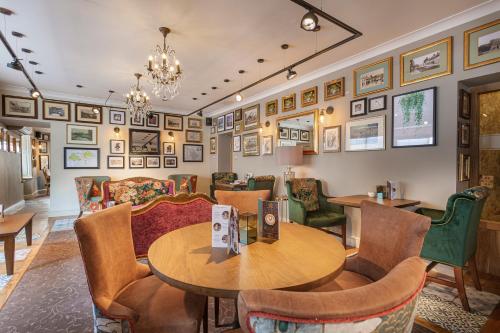 a dining room with a table and chairs at The Crown Hotel, Boroughbridge, North Yorkshire - The Coaching Inn Group in Boroughbridge