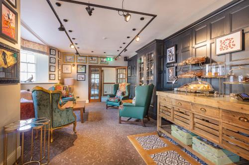 a living room with blue walls and furniture at The Crown Hotel, Boroughbridge, North Yorkshire - The Coaching Inn Group in Boroughbridge