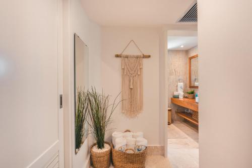 a hallway with two baskets of towels on a wall at 1BR Apt at Green One in Muñoz