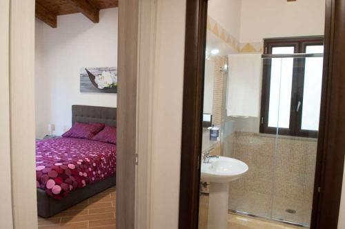 a bathroom with a bed and a sink in a room at IL Casale Di Gio in Naples