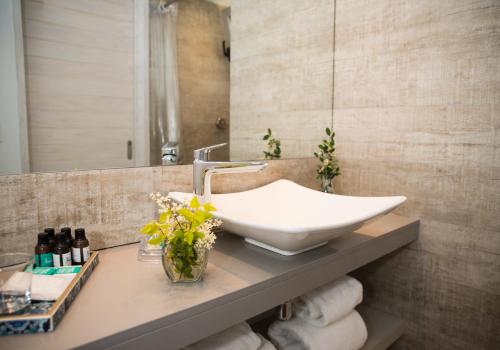 a bathroom with a sink on a counter with towels at Anastasio Hotel & Beach Club in José Ignacio