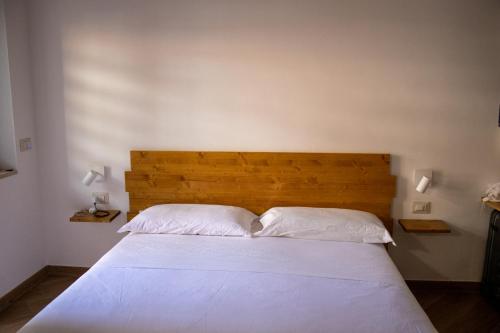 a bedroom with a large bed with two white pillows at B&B JONIO Roma in Rome