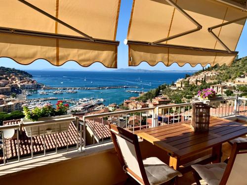 a balcony with a table and a view of the ocean at Terrazza 81 in Porto Santo Stefano