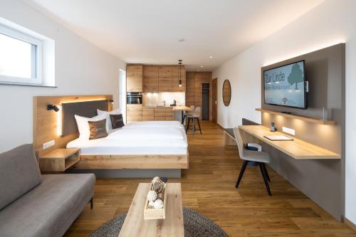 a hotel room with a bed and a couch at Hotel Restaurant Zur Linde in Erbach