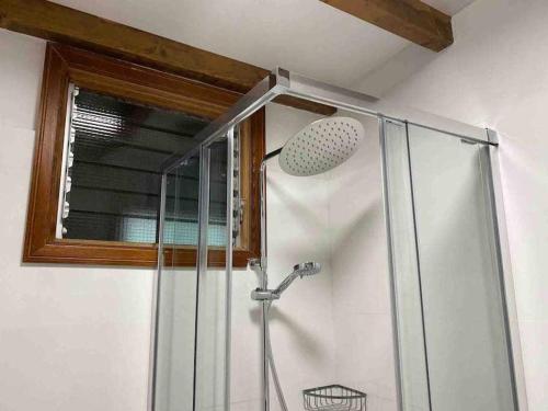 a bathroom with a shower with a glass door at Teide Hideaway in Vilaflor