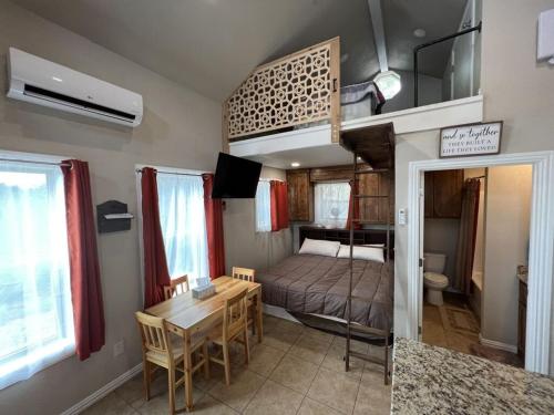 a bedroom with a bed and a table in a room at Inspiration Cabin at Lake Godstone in Jacksboro
