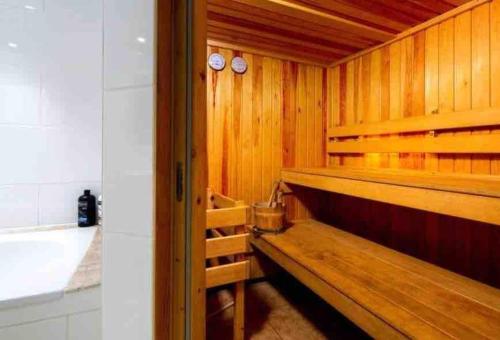a sauna with wooden walls and a wooden bench at Artist's Retreat - Old Signal Box - Private Sauna in Bath