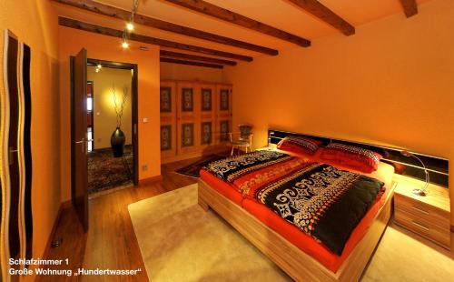 a bedroom with a large bed in a room at Große Ferienwohnung Hundertwasser am Dreisessel in Altreichenau in Neureichenau