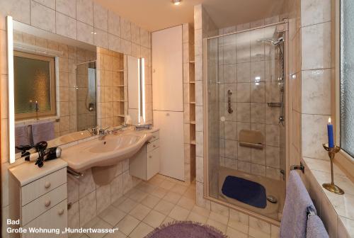 a bathroom with a shower and a sink and a shower at Große Ferienwohnung Hundertwasser am Dreisessel in Altreichenau in Neureichenau