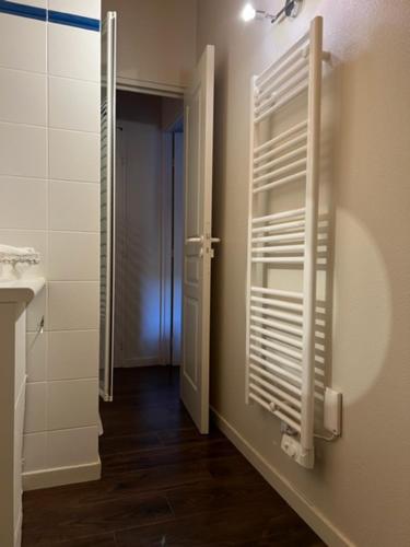 a bathroom with a mirror and a door with a window at Appartement style chalet à Saint Lary Soulan. in Saint-Lary-Soulan