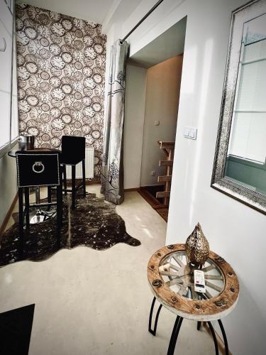a living room with a table and a mirror at Sopot Spa Apartament in Sopot
