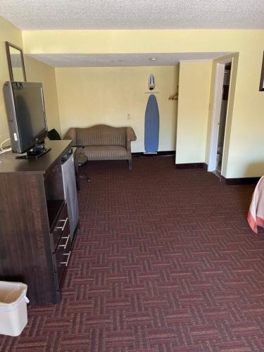 a living room with a couch and a tv at ROYAL INN in Bellmawr