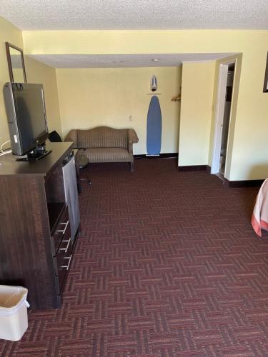 a living room with a couch and a tv at Royal Inn in Bellmawr