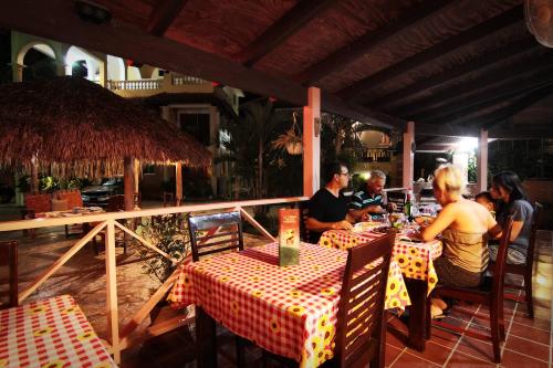 um grupo de pessoas sentadas numa mesa num restaurante em Aparta-Hotel Villa Baya em Bayahibe