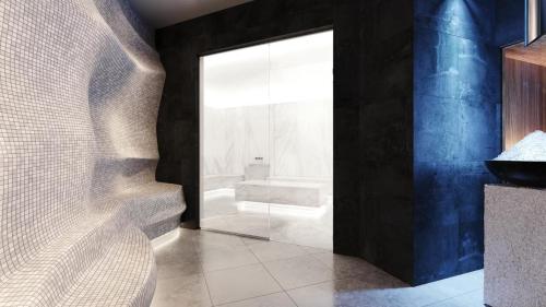a bathroom with a shower and a glass door at Woodside Kopaonik by Ister in Kopaonik