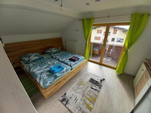 a bedroom with a bed and a large window at Ferienwohnung Bergtroll in Uderns