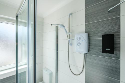 a shower in a bathroom with a glass door at The Douglas - Spacious 2 bed apartment in Uddingston in Uddingston