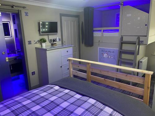 a bedroom with a bunk bed and a purple room at The Sawley Arms in Ripon