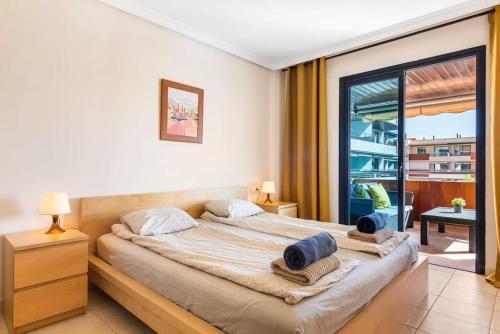 a bedroom with a large bed and a large window at Bright and welcoming holiday home in Puerto de Santiago