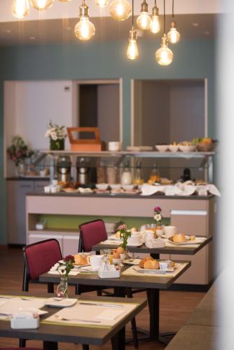 a restaurant with tables with food on them at Hotel Montana in Geneva