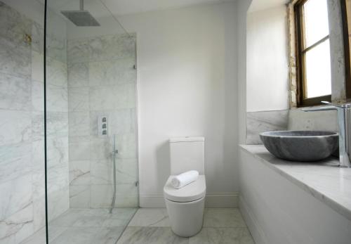 a bathroom with a sink and a toilet and a shower at Hillside House - beautiful 16th century house with Wifi, Parking, games room, Netflix in Oakhill