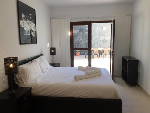 a bedroom with a bed with two towels on it at El Olivo Beautiful Rural location 3 bed villa in Conil