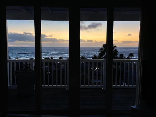 a view of the ocean from a house window at Sea Five Boutique Hotel in Cape Town