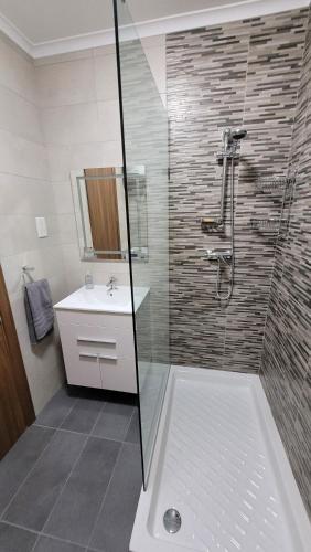 a bathroom with a shower and a sink at Lovely Apartment with Side Sea View in St. Paul's Bay