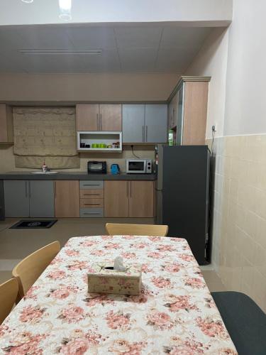 a kitchen with a table with a box on it at D’Lestari Homestay in Seri Kembangan