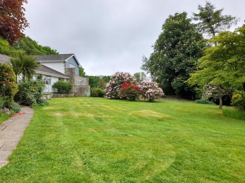 a yard with green grass and a house at Fairwater Head in Axminster