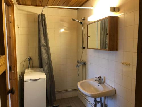 een badkamer met wastafel en douche met spiegel bij Rukankieppi in Ruka