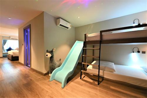 a kids room with bunk beds and a slide at Moose Hotel Nimman in Chiang Mai