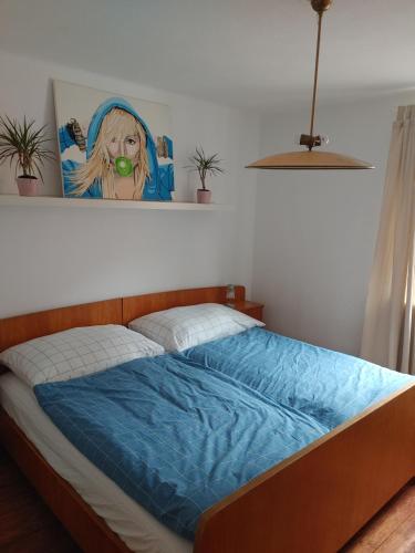 a bed in a bedroom with a painting on the wall at Himmel in Ebensee