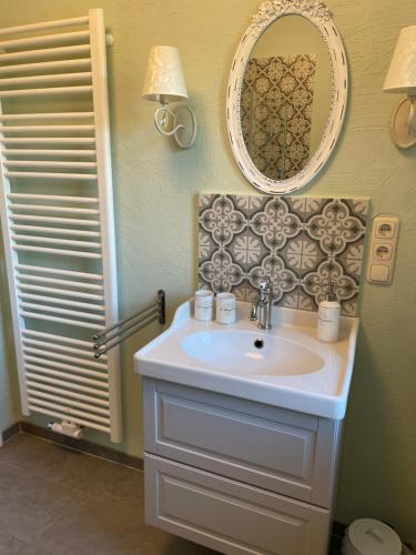 a bathroom with a sink and a mirror at Neue Ferienwohnung im alten Forsthaus in Rüdesheim am Rhein