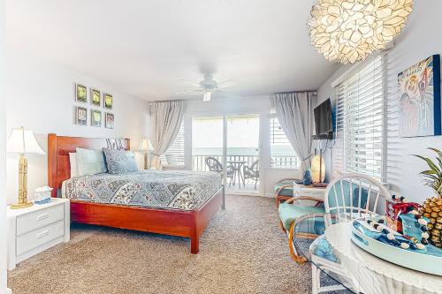 a bedroom with a bed and a balcony at Kapa'a Sands 07 in Kapaa