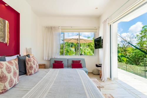a bedroom with a large bed and a large window at Villa Calma, Chic & Mexican Villa, a True Oasis Pool, Security in Tulum