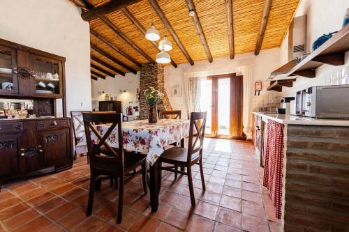 a kitchen with a table and chairs in a room at Agroturismo Flores do Campo in Vila Verde de Ficalho