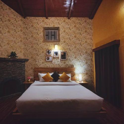 a bedroom with a large bed in a room at Family Retreat - The Forest Dak Bangalow in Rāmgarh