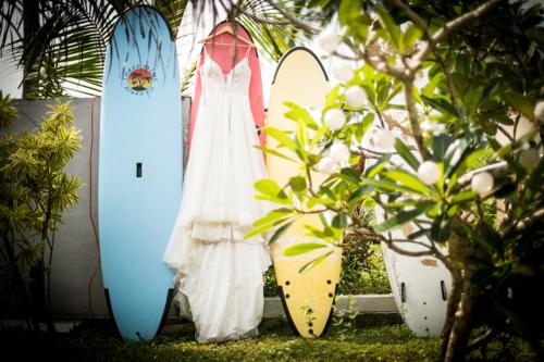a woman in a dress standing in front of surfboards at Infinity of Sri Lanka in Paiyagala South