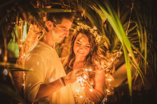 a man and a woman holding a string of lights at Infinity of Sri Lanka in Paiyagala South