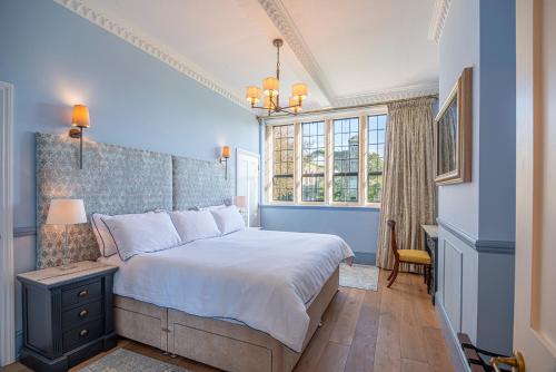 a bedroom with a large bed and a window at Herons Wood at Greyfriars in Winchelsea