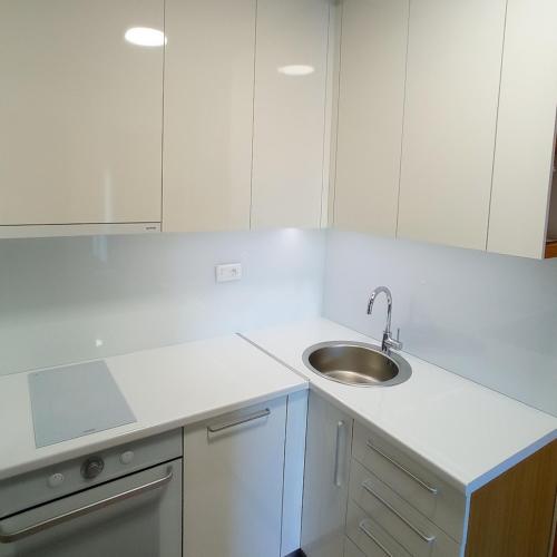 a white kitchen with a sink and white cabinets at KaLuMa in Belgrade